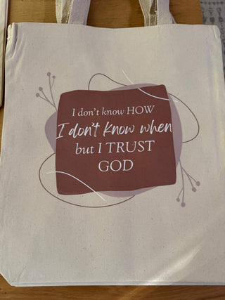 Tote bag with a motivational quote on a wooden surface