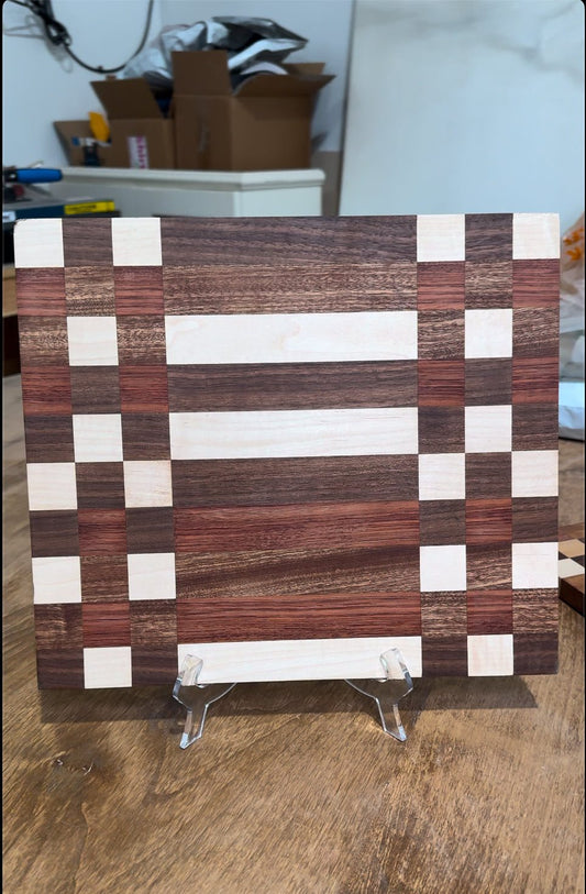 Wooden checkered cutting board on a stand with a blurred background