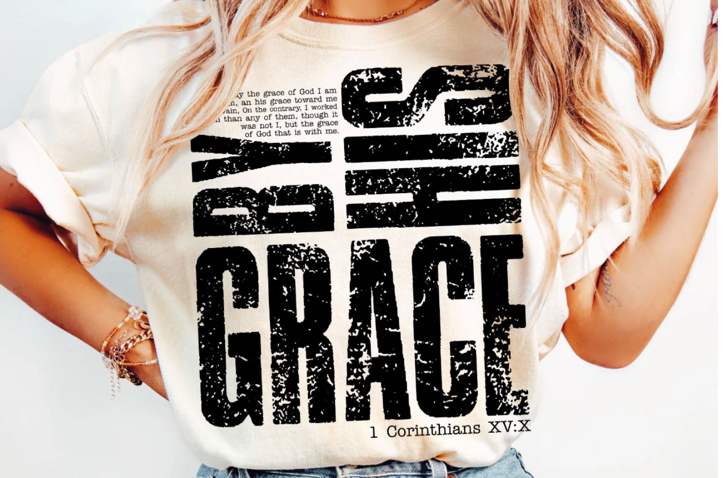 Person wearing a white t-shirt with black text design on a plain background